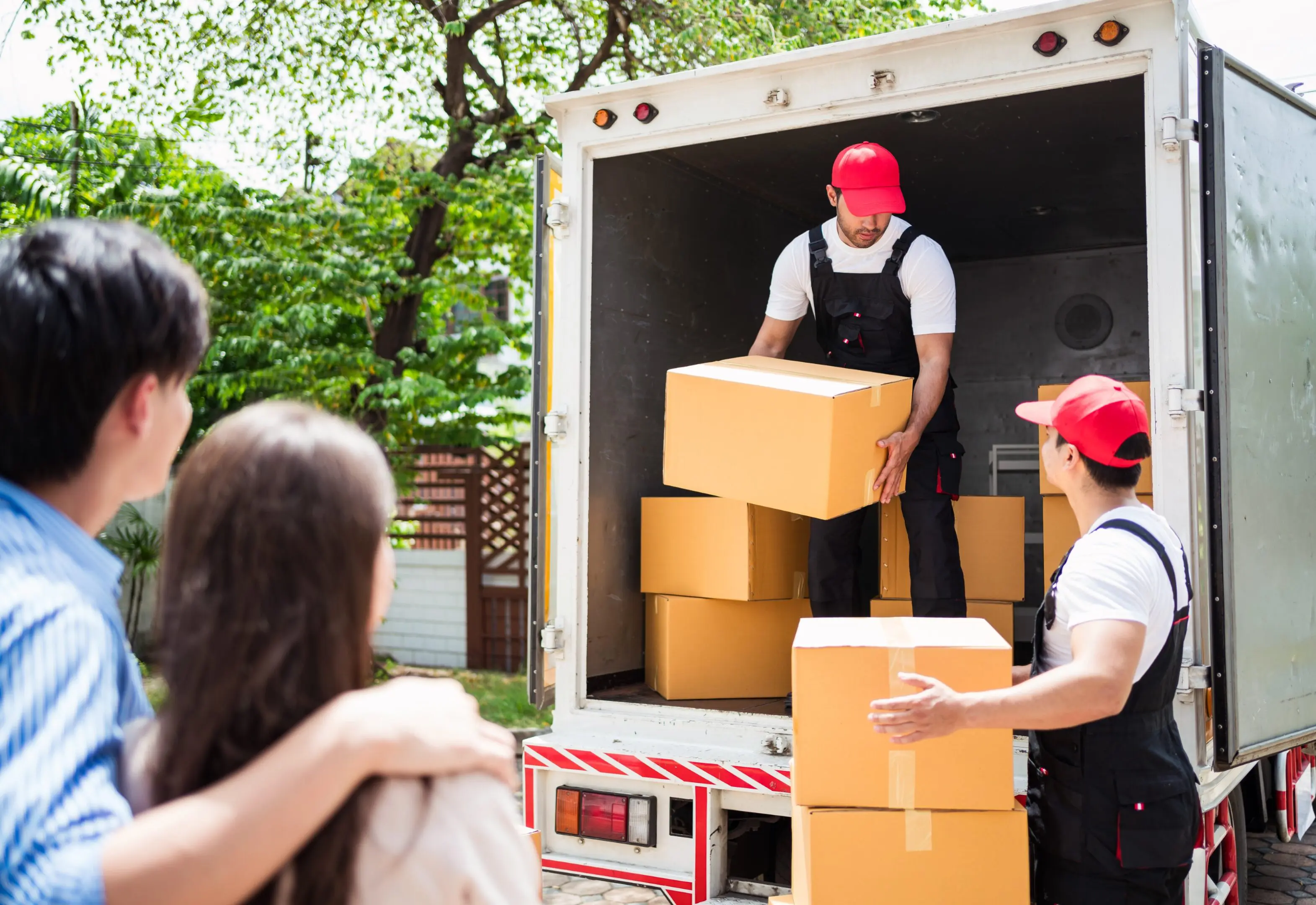Movers loading boxes into a truck.