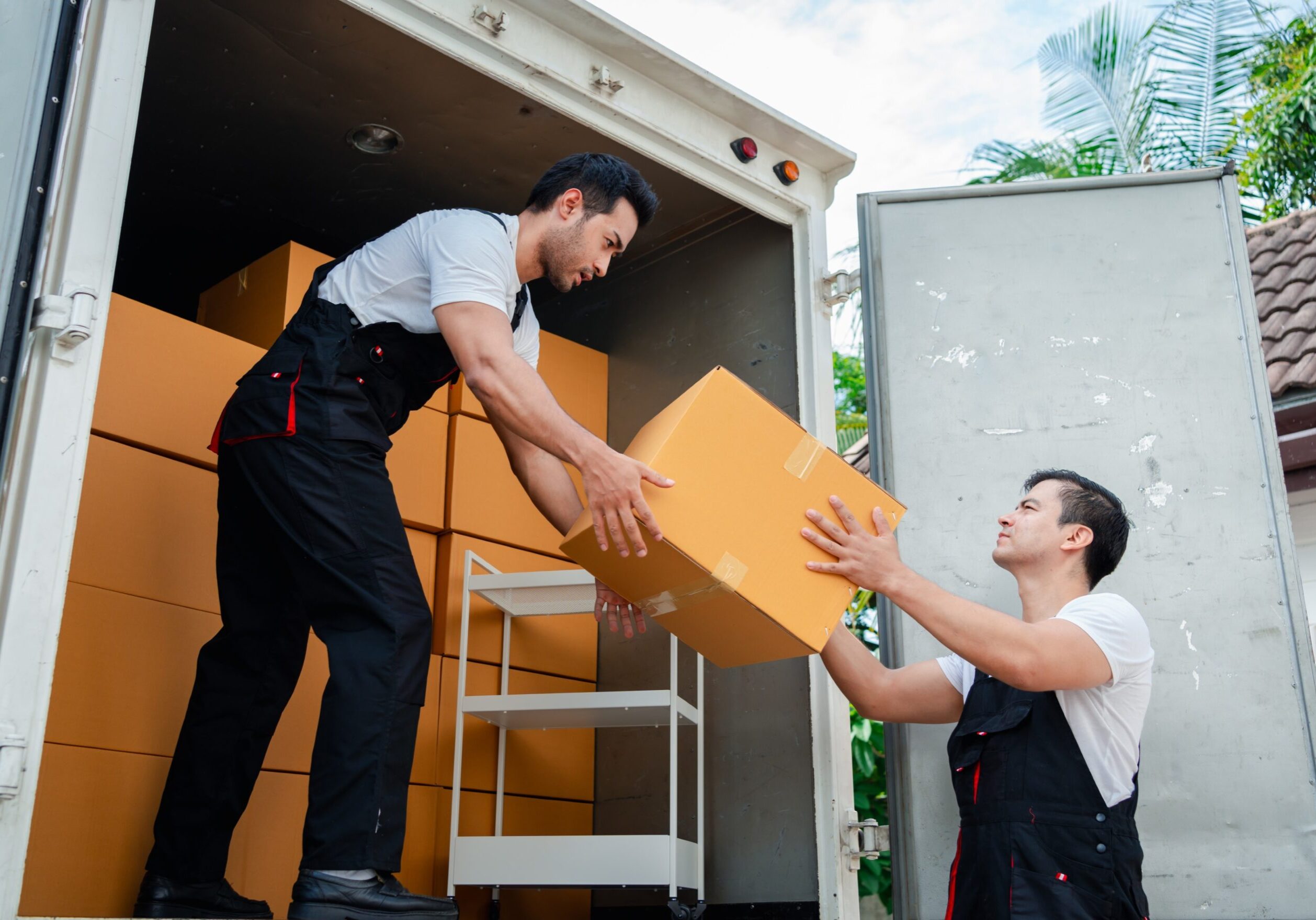Movers unloading boxes from a truck.